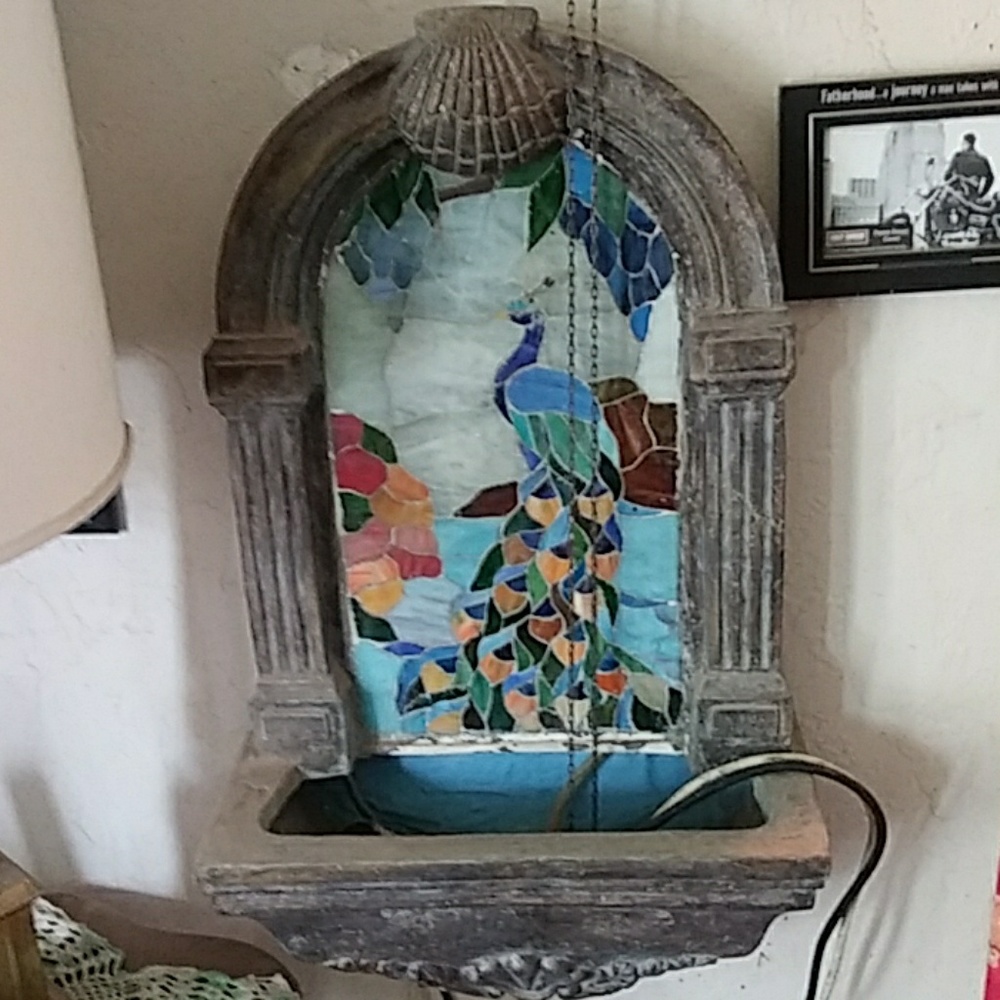 Stained glass wall hanging fountain.